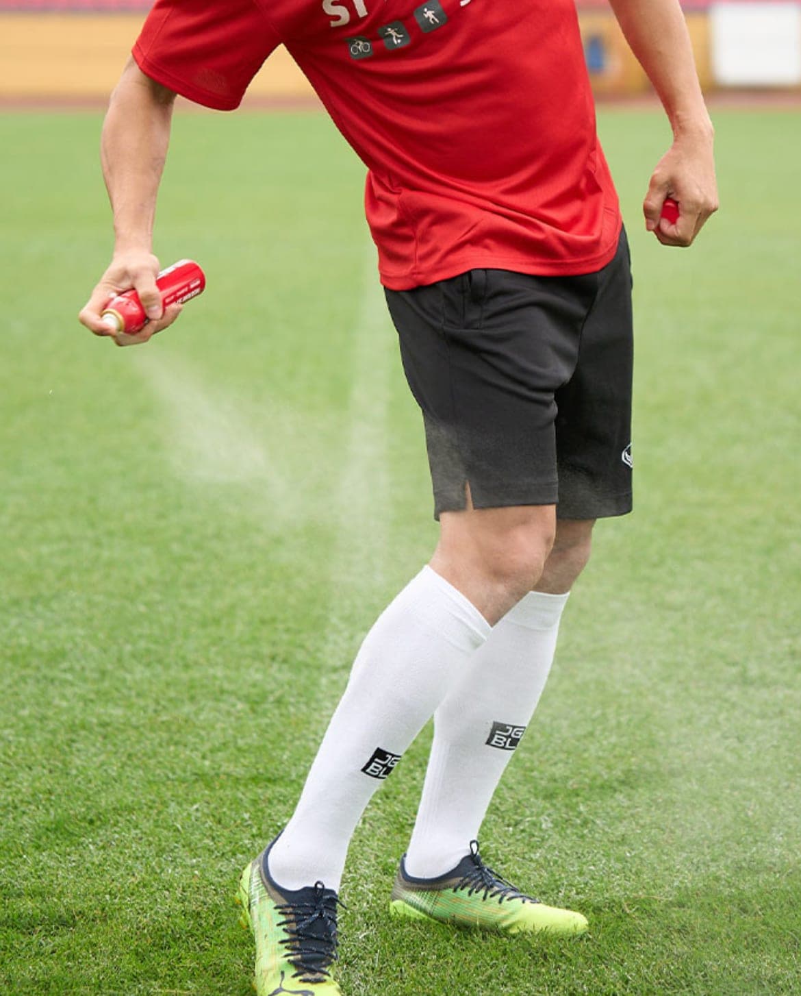 Filipino athlete applying Starbalm spray on the pitch
