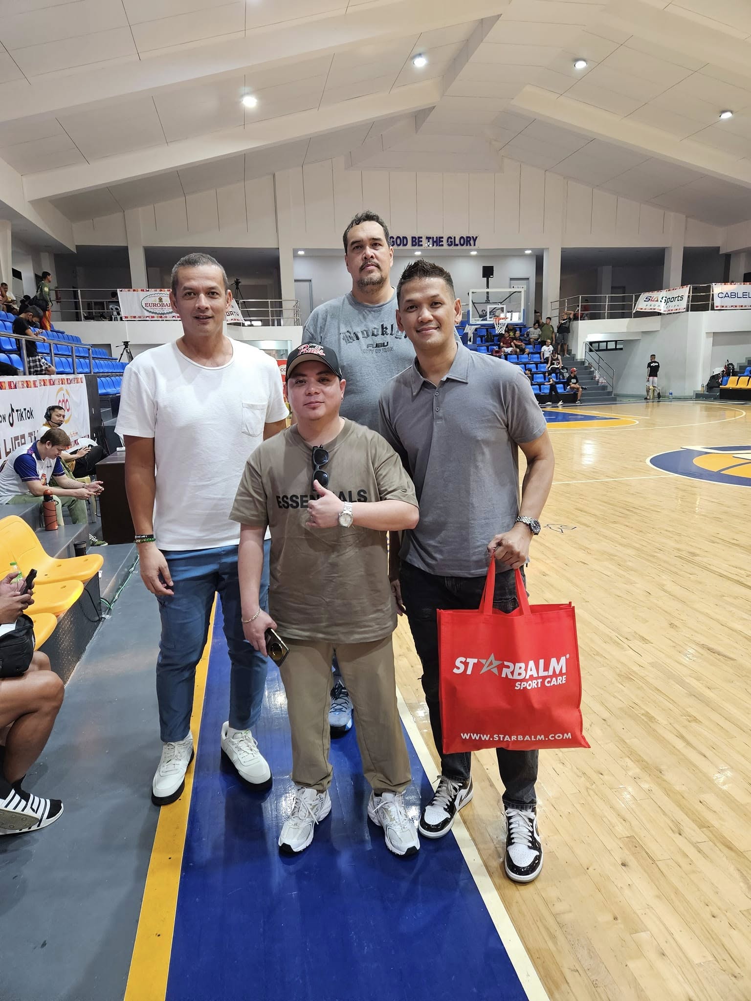 Filipino basketball players at a varsity tournament holding a Starbalm sport care bag